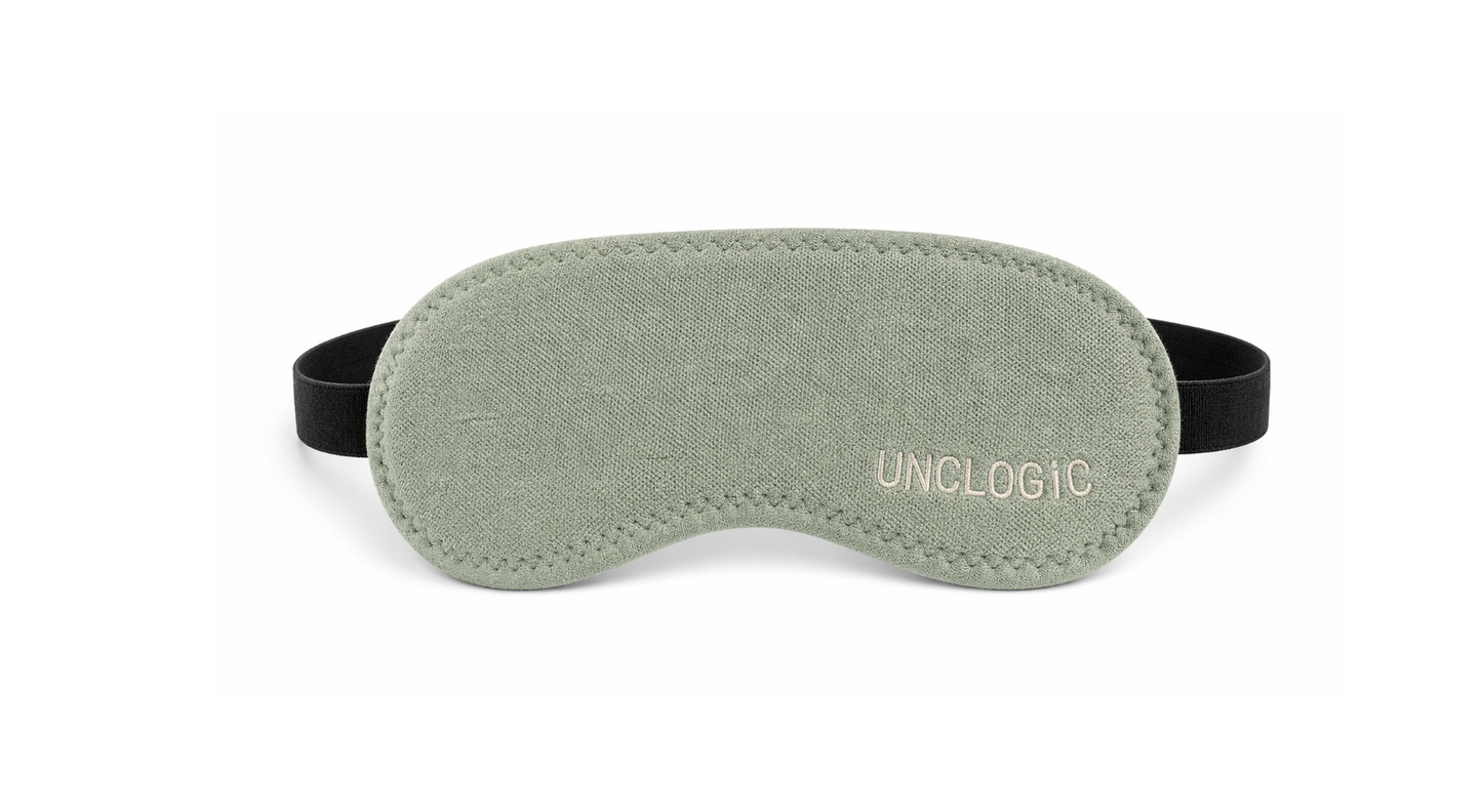 Green UNCLOGIC eye mask with branding — sleep mask and light-blocking mode for restful recovery