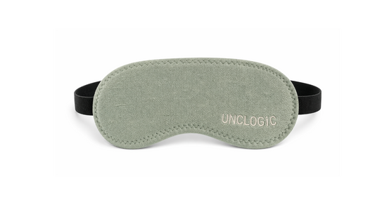 Green UNCLOGIC eye mask with branding — sleep mask and light-blocking mode for restful recovery
