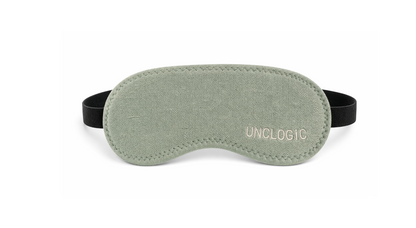 Green UNCLOGIC eye mask with branding — sleep mask and light-blocking mode for restful recovery